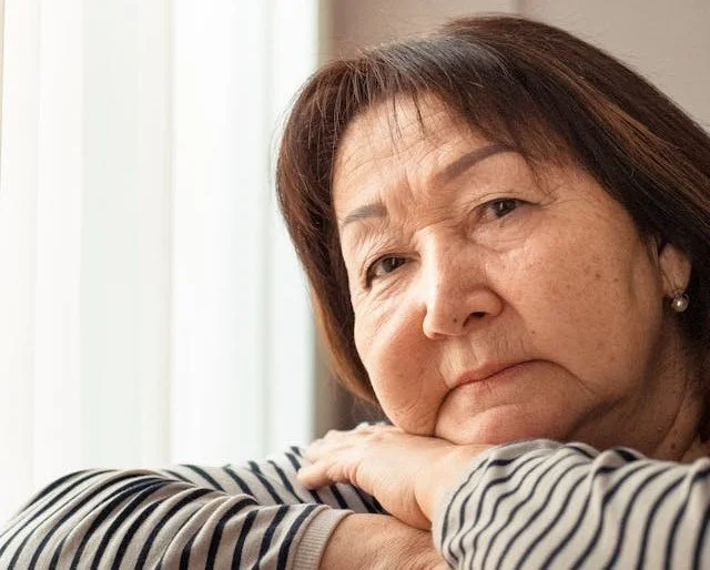 Older woman reflecting on emotional wellness and how do women's hormones influence anxiety during different stages of life
