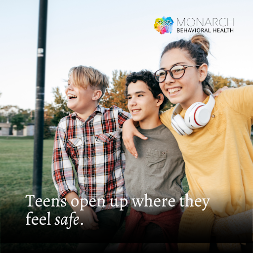 Group of teens standing together outdoors with arms around each other, smiling and relaxed, illustrating creating safe spaces for teens where they feel comfortable opening up and being themselves.