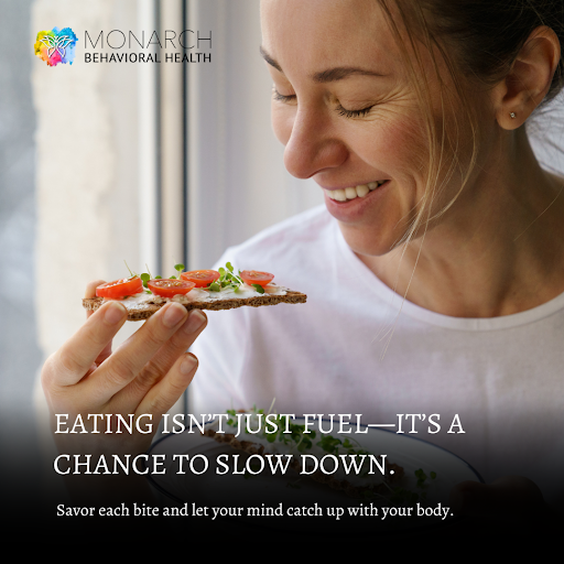Person smiling while holding a slice of food and eating slowly, illustrating mindful eating and the practice of slowing down to reconnect with the body and mind.