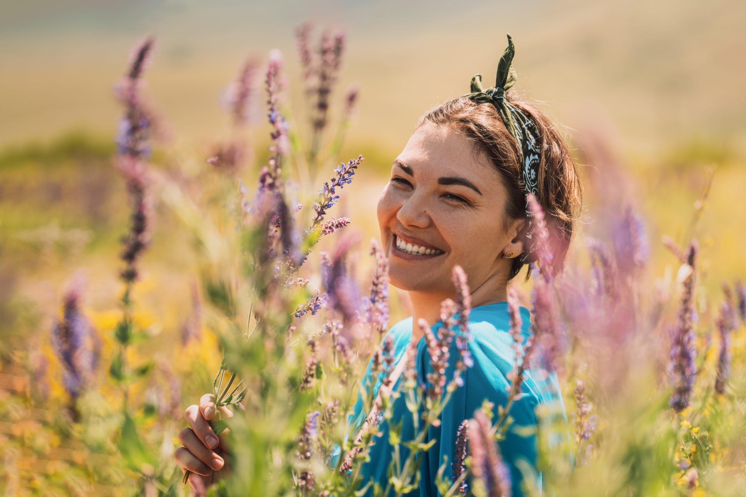 Girl in purple flowering ginseng bushes.