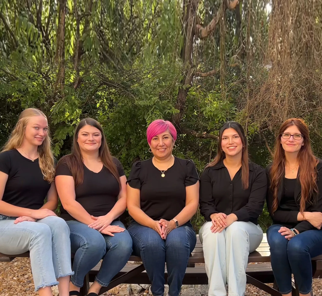 Mental health support team in San Antonio group photo of Monarch Behavioral Health staff sitting outdoors together