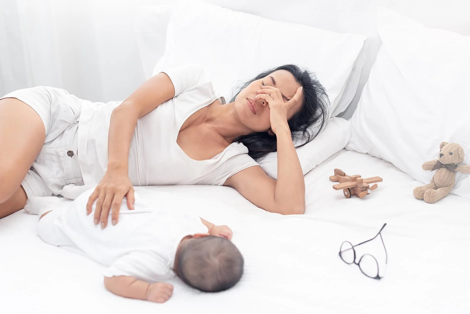  A tired mother covers her face as she comforts her baby. This could represent the strain postpartum therapy in San Antonio, TX can address. Contact a postpartum therapist in San Antonio, TX to learn more about postpartum depression treatment in San Antonio, TX and more! 78258 