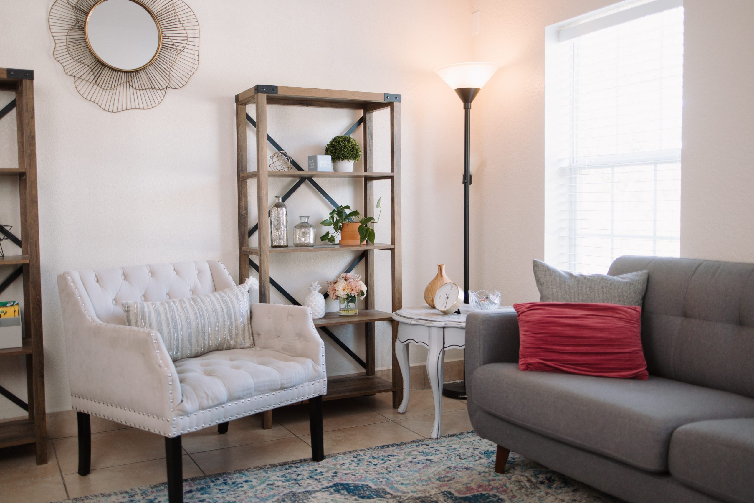 Wide view of a counseling office with chairs, side table, and floor lamp.